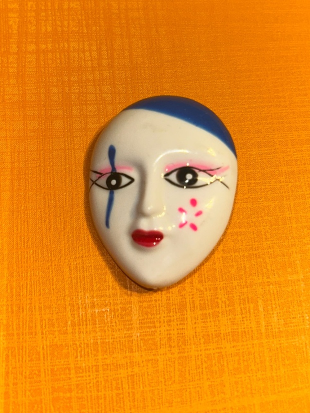 Vintage White Ceramic Face Brooch with Blue and Pink Accents